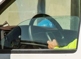 Is it legal to be on your phone at a red light in California?