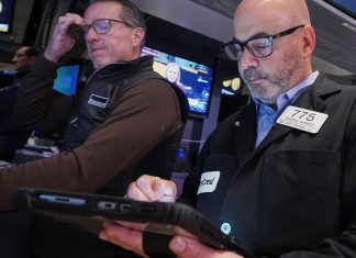 Wall Street swings through another unsettled day ahead of a crucial couple of tests